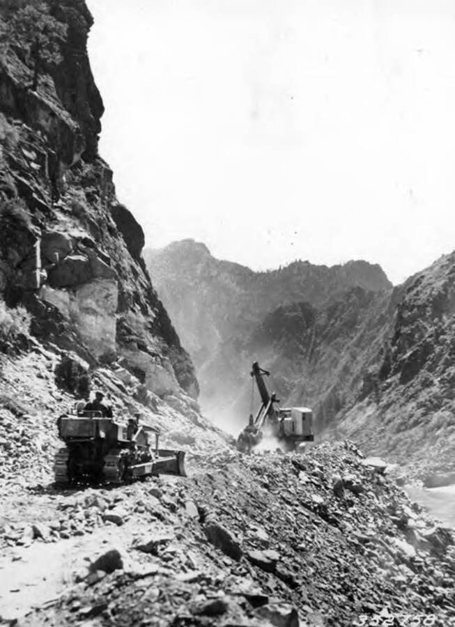 Shovel and tractor work following the blasting of a roadway on the Salmon River road, below the Middle Fork, Idaho.