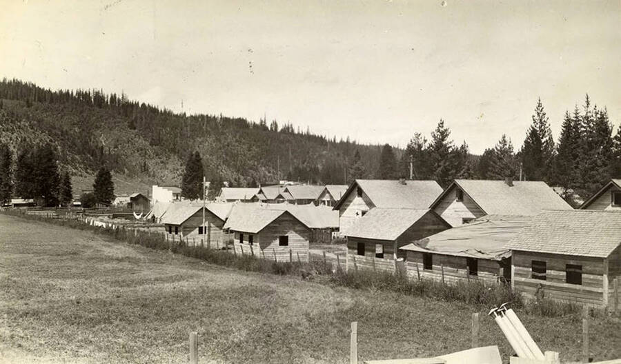 A view of an abandoned Rutledge logging camp that the CCC is moving into. Tents can be seen through some of the buildings. Back of photo reads: 'CCC Camp moving into abandoned logging camp buildings. Clarkia, Idaho 7/4/33 St. Joe National Forest.