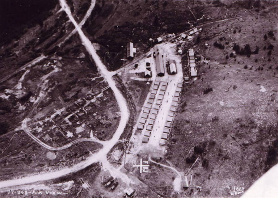 Aerial view of Cotter CCC Camp, F-161. There is a geoglyph near the camp reading F-161. Writing on the photo reads: 'Air view Cotter F-161 Company 570 Leo's Studio'.