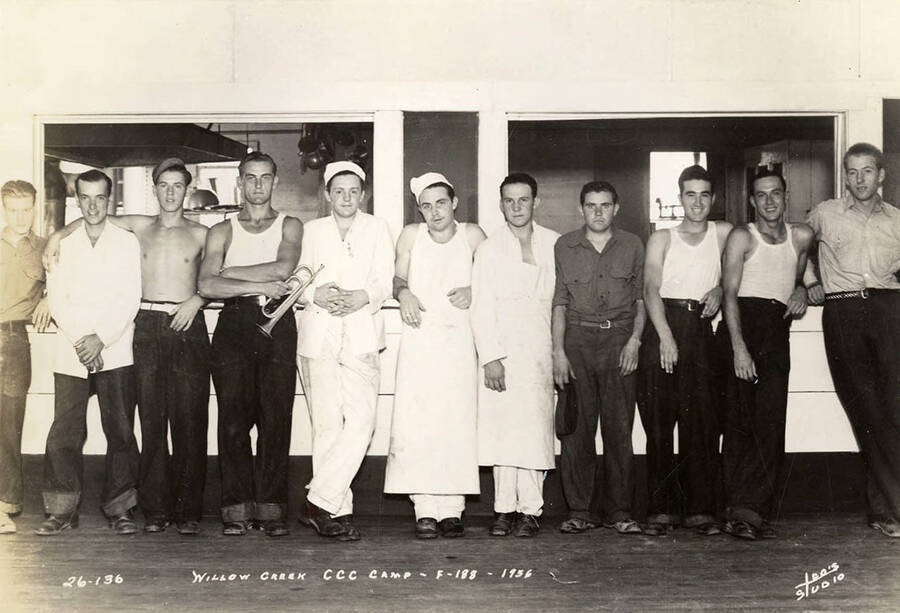 Group photo of CCC cooks at Willow Creek CCC Camp, F-188. Note the man holding a bugle. Writing on the photo reads: 'Willow Creek CCC Camp F-188 1936 Leo's Studio'.