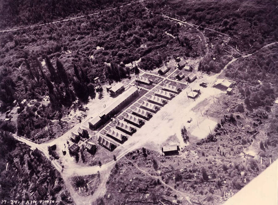 Aerial view of Elk River CCC Camp. Note geoglyphs that read: '1238' and 'F-138'. Writing on the photo reads: 'Air photo Elk River F-138 Company 1238 Leo's Studio'. Back of photo reads: 'p. 79 Elk River F-138 Company 1238'.