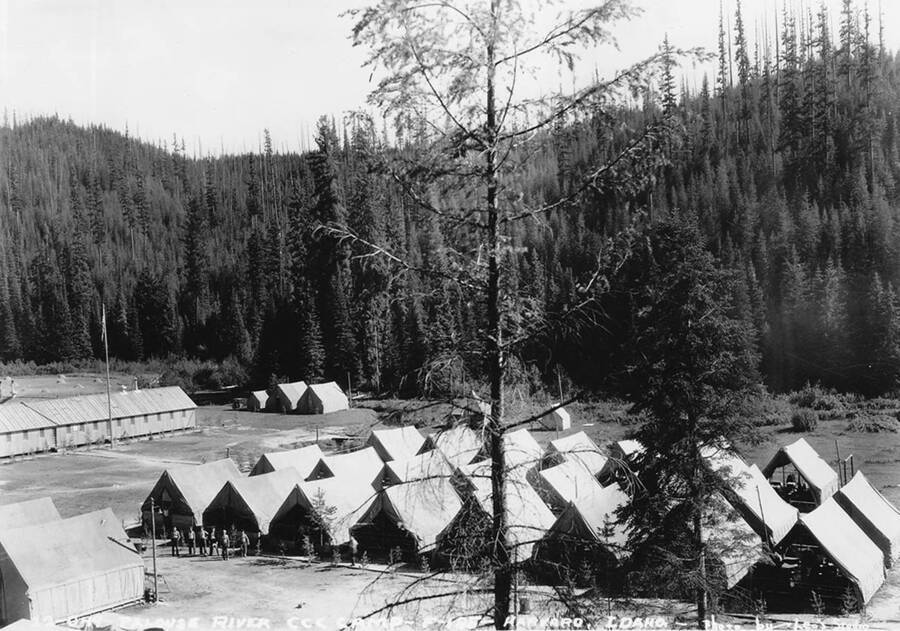 View of camp P-185 near Potlatch and Harvard, Idaho on the Palouse River. Back of photo reads: '25-13-52 1930's Harvard Palouse R [unidentifiable name] of N. Idaho' There is also a stamp from Leo's Studio, the photographer.