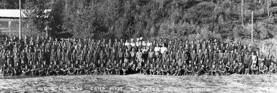 Group portrait of company 1236 near Wallace and Prichard, Idaho. The writing on the phot reads: 'CCC Company 1236 Camp F-132 Big Creek Number 2 Idaho.'