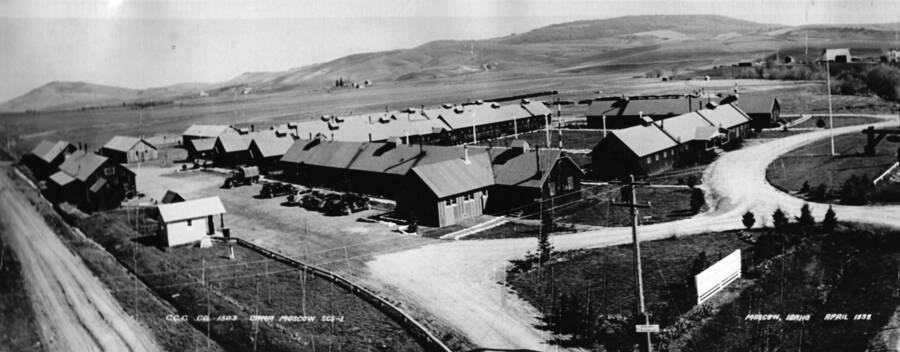 Aerial camp view of Camp SCS-1 near Moscow, Idaho. The writing on the photo reads: 'CCC Company 1503 Camp Moscow SCS-1 Moscow, Idaho April 1939. The back of the photo reads: 'also 1-1-99 on Lewiston Highway S of Moscow later Chinese Village and Plantation Moscow CCC Camp April 1933'.