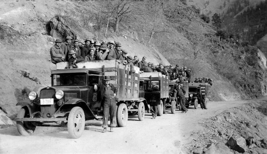 CCC company in trucks, with their drivers, homeward bound from work. Typewriting on the photo reads: '#23 _-107 homeward bound from work'.