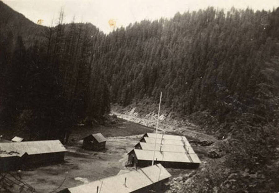 A view of CCC Camp, F-187, the surrounding river, and the valley. The back of the photo reads: 'Company 1239 F-187 August 29, 1938'.