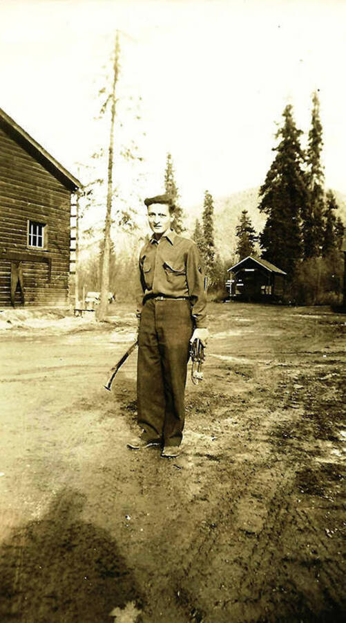A CCC maintenance man, likely at the Forest Service Headquarters. CCC Camp Big Creek #2, F-132. Back of the photo reads: 'Forest Service Hqtrs?? One of our maintenance crew'.