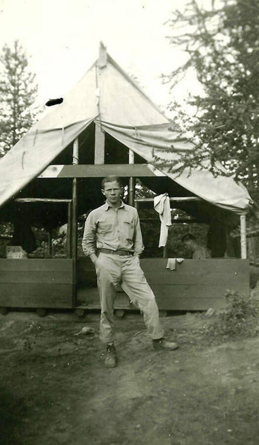 A CCC man in front of a tent barrack at CCC Camp Big Creek #2, F-132.