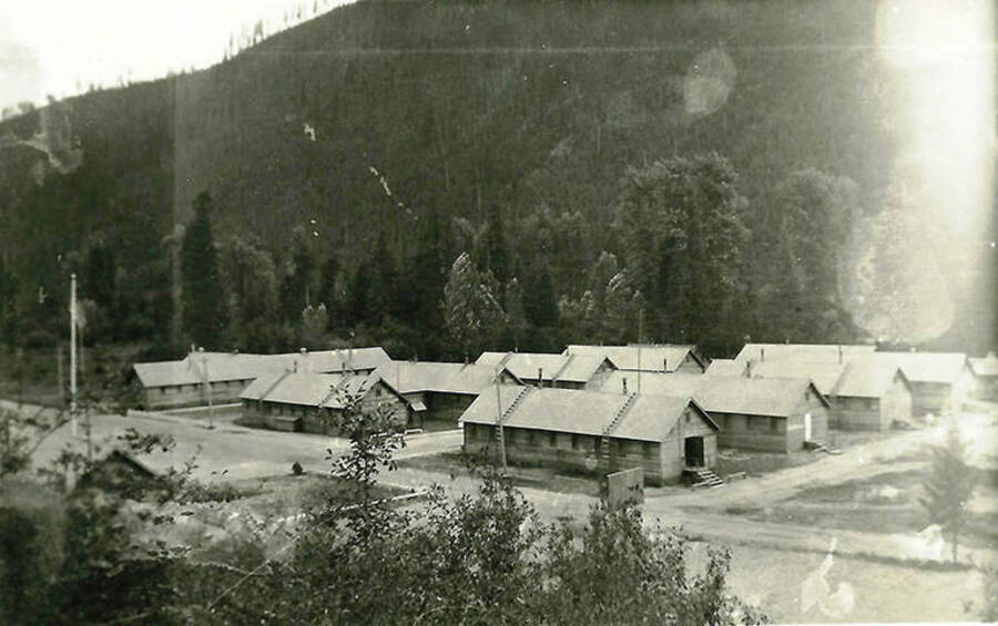 A view of CCC Camp Big Creek #2, F-132. A forest-covered hill rises in the background.