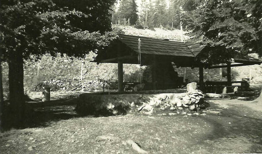 A shelter and water fountain at Shoshone County Park. Built by CCC Company 531. Back of the photo reads: 'Shelter house in Shoshone Co. Park water fountain in foreground.'