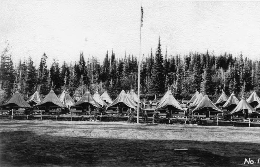 A view of the tent barracks and flagpole at Camp Black Bear. Taken in August. Description of photo says Camp number is P-262.