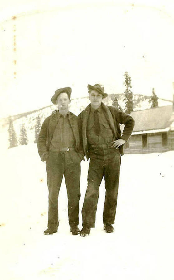 Two CCC men pose at CCC Camp Big Creek, F-132, in the snow. Back of the photo reads: 'Couple of 'rookies' ready for  liberty'