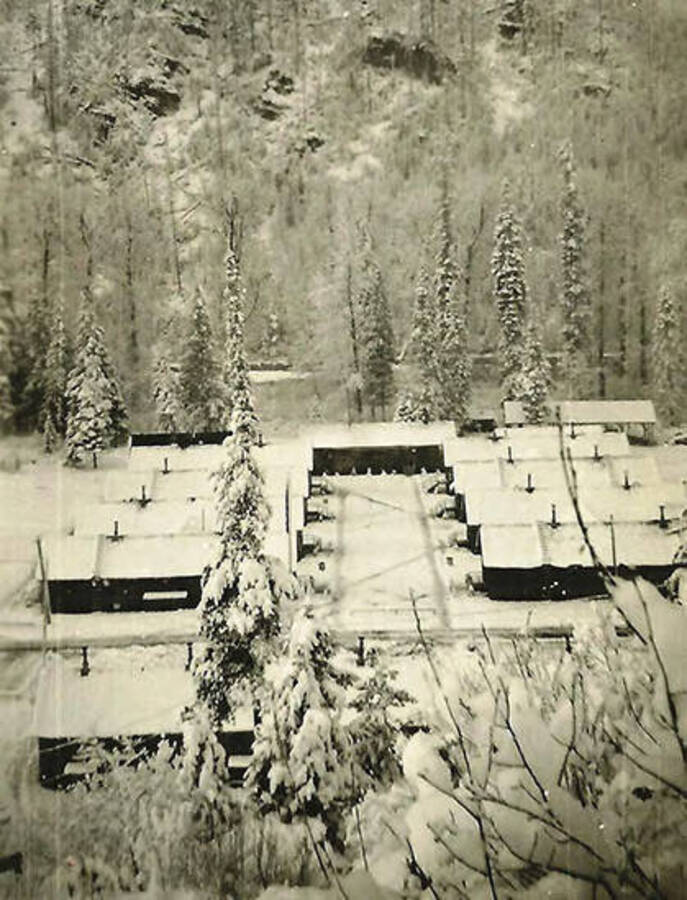 A view of CCC Camp Big Creek #2, F-132, covered in snow. Back of photo says: 'Winter at Camp Big Creek'.