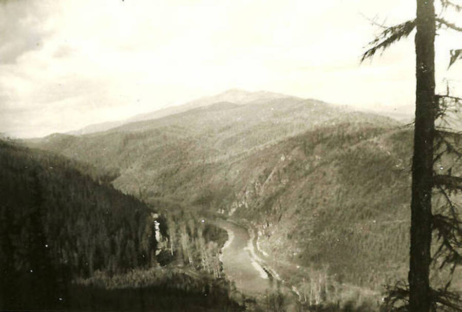 An overview of the valley that holds CCC Camp Big Creek #2 and the North Fork of the Coeur d'Alene River. Back of photo reads: 'I really loved these mountains. Part of the Bitterroots between Wash state and Montana. Called the panhandle region of Idaho.'