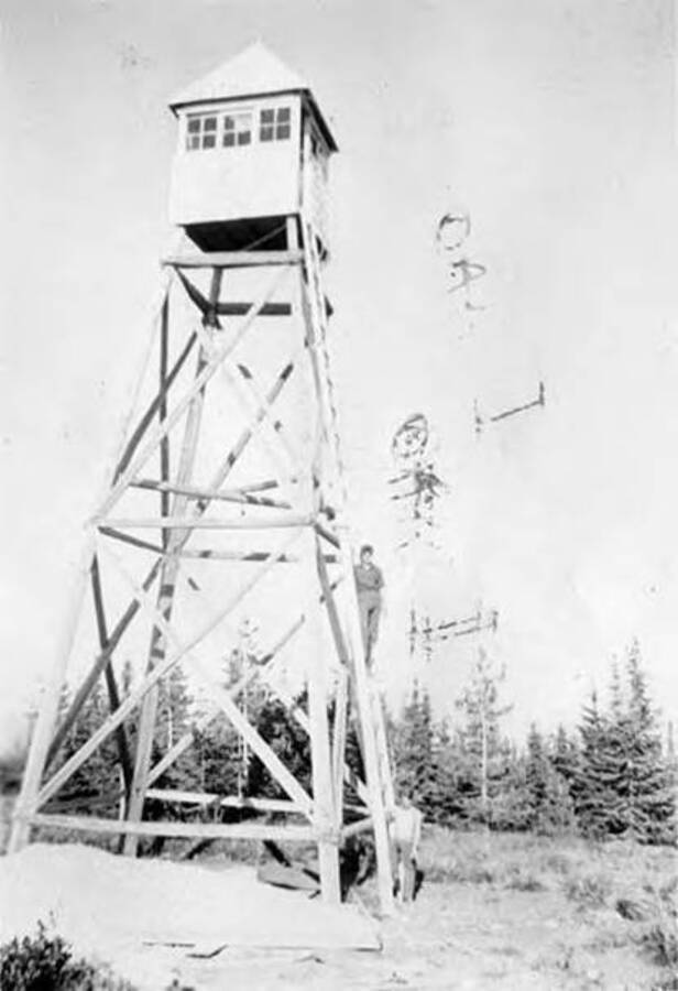 Two men posing next to or on a lookout tower. Writing under the photo reads: 'Lookout Tower Bic Berthia'