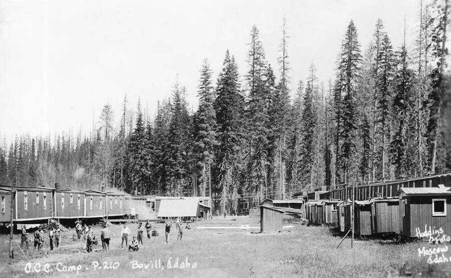 A view of CCC Camp P-210 near Bovill, Idaho. The writing on the photo reads: 'CCC Camp - P210 Bovill, Idaho Hodgins Foto Moscow, Idaho'.