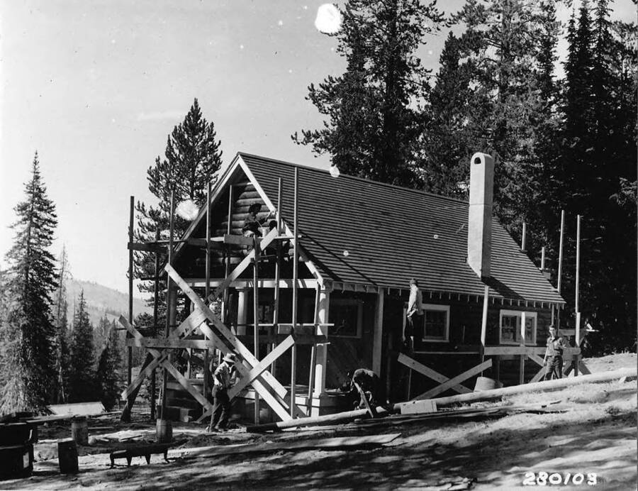 CCC crew constructing a Guard Station in the Boise National Forest. Back of photo reads: 'CCC activities Constructing Guard Station, Boise National Forest, Idaho. Credit Line! This print may be reproduced with the following credit line 'Photo by the U.S. Forest Service'.'