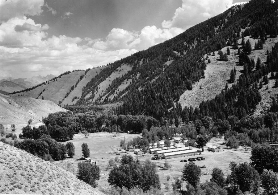 A CCC Camp sits in a valley as seen from the top of a nearby hill.
