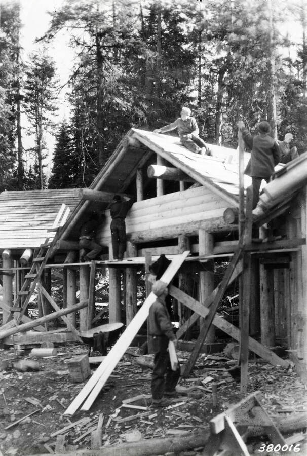 A CCC work crew building a lodge out of logs.