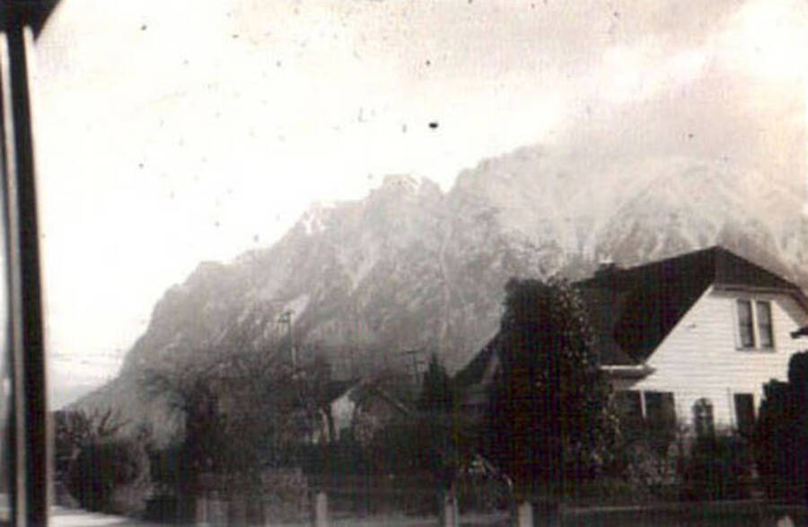 Photo of the mountains behind a row of houses. Writing under the photo reads: 'Cascade Mt'.