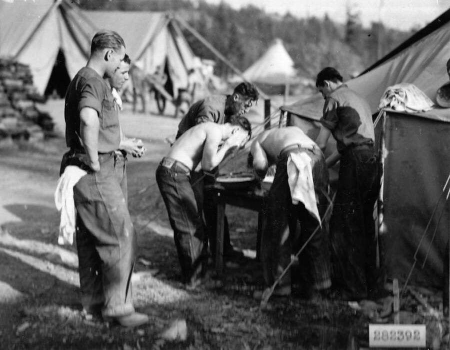 Several CCC men washing up at temporary CCC Camp Remount Depot in the Lolo National Forest, Montana.
