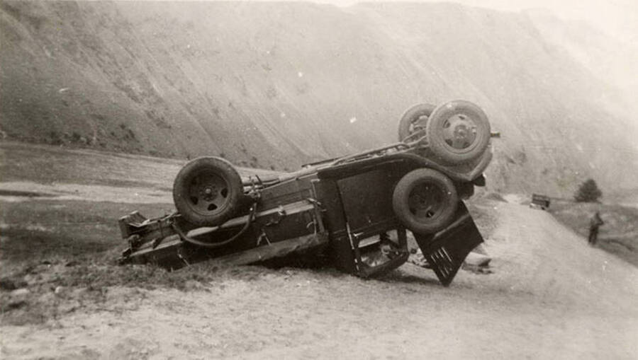 Photo of an overturned truck near the river. Writing underneath each photo is one word that makes the sentence: 'This truck overturned by accident' Word on this image is: 'Truck'.