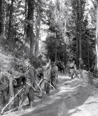 Roadwork crew with shovels working on Shafer Butte road.