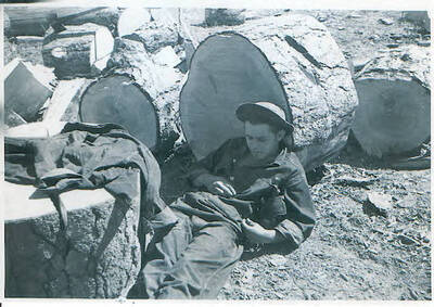 John Rais, Cincinnati, Ohio. Resting against cut log. Camp Smith Ferry, 1939.