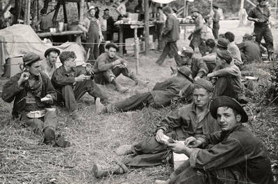 Group photo of a CCC fire crew resting and eating after fighting the Spirit Lake Fire.