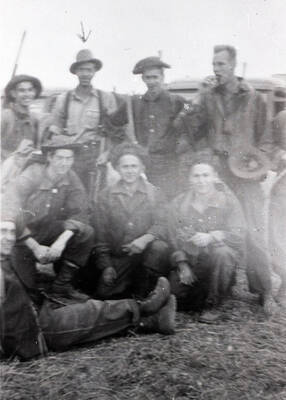 A group of CCC men pose for a group photo. An arrow points to the man in the back row, second from the left.