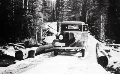 A pickup truck on a snowy bridge near Green Mountain CCC Camp.