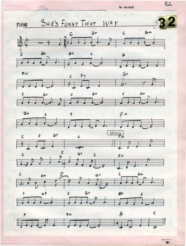 Cream-colored page pasted over pink page bound in a music manuscript book. At the top, "Piano" and "She's Funny That Way" is written and underlined in black pen ink. In the top right corner are "3" and "2" gold reflective stickers. Written above the pasted page are "N. Moret" and "32" in the right corner in black marker. The entirety of the music and notation is written in black pen. There is a small water stain in the top left. "She's funny that way" (1929) was composed by Charles N. Daniels (pseudonym: Neil Moret; 1878-1943) and Richard Whiting (1891-1938) for the short film "Gems of M-G-M." Cheatham released a recording of this piece on his record It's a Good Life (1982), and Cheatham and Nicholas Payton (1973-) released a recording on Doc Cheatham & Nicholas Payton (1997).