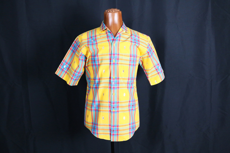 A multicolored Brigade Unlimited short sleeve shirt with shirttail hem.