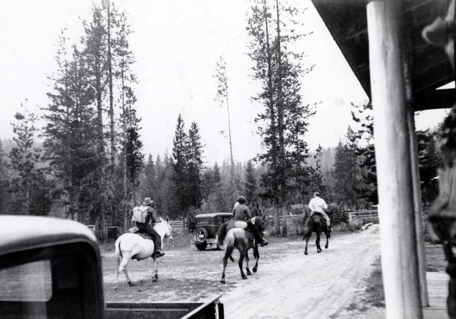 Jimmy Rice, on white mule, Joe Gray, going to a fire.  Others unidentified.