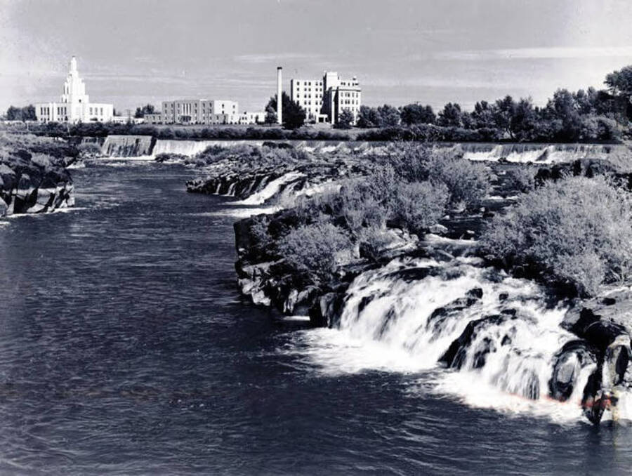 View of the falls with town in distance. Idaho Falls, Idaho.