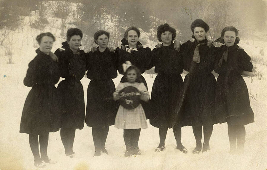 The 1904 women's basketball team. From (l to r) Clara Stockwell, Aliter Adair, Nellie Woods, Mabel Smith, Mattie Stockwell, Florence Smith, Dorothy Bovill, Edna Woods (child in front).