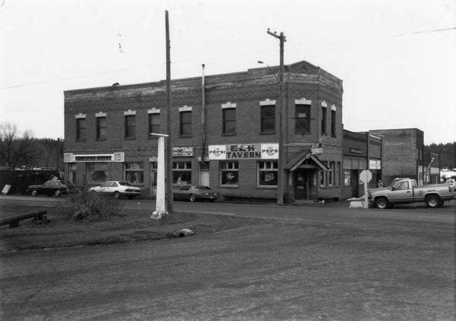 Bovill's first state bank, with cars parked on the street outside.