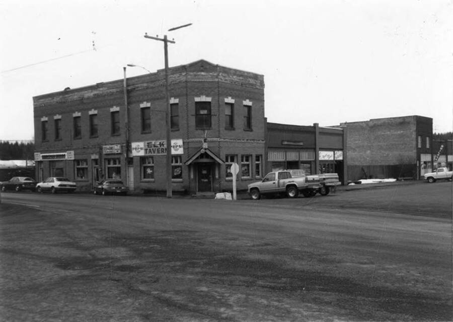 Cars parked on the street outside of Bovill's first state bank.
