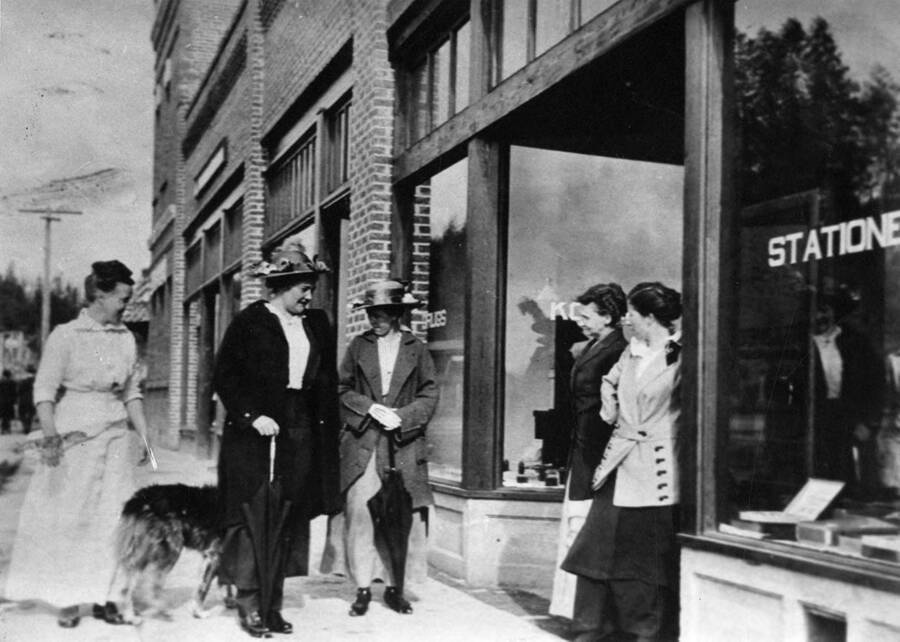 A group of women stand in front of the drug store on Main St. in Bovill. L to R: Della Crawford (druggist), Mrs. Dave Ellison (owner of the Spokane Hotel), Mrs. Charles White, Mrs. Carlton Stockwell and Mrs. R. T. Witty.