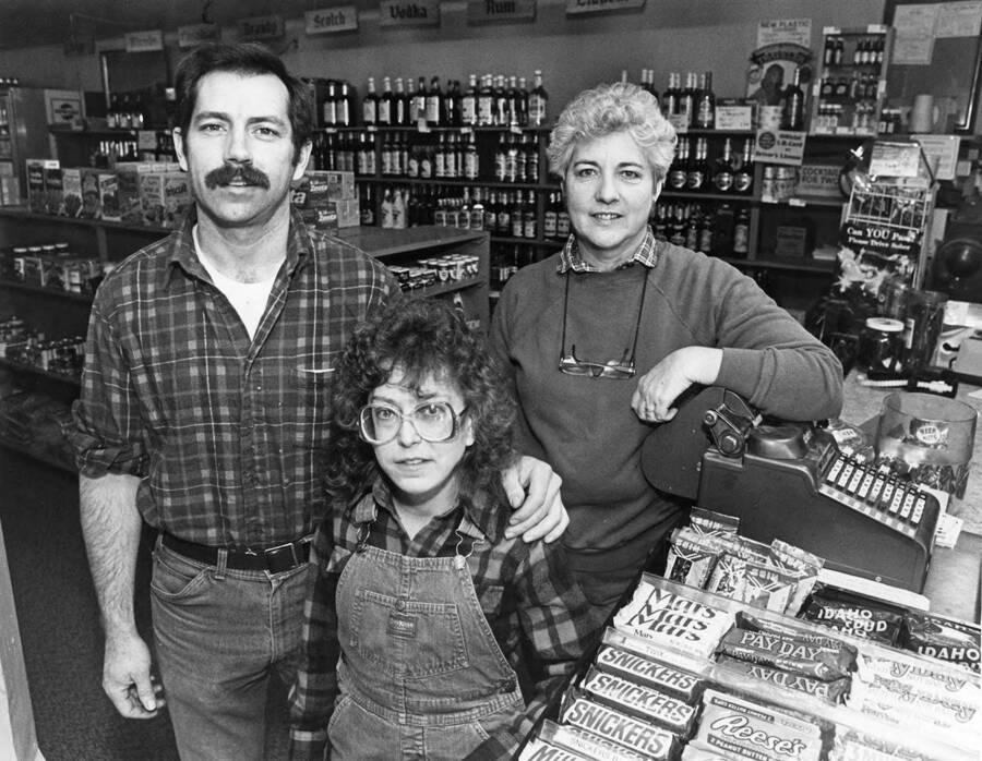 A Bovill family stands in a store surrounded by merchandise.