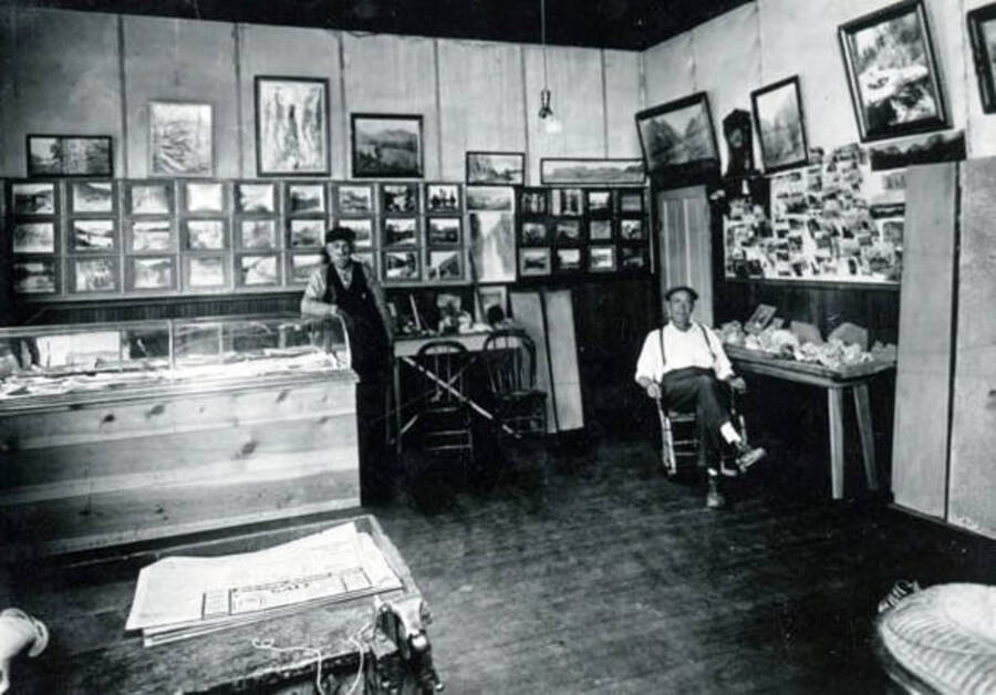 Interior of an office or store displaying many pictures on the wall.