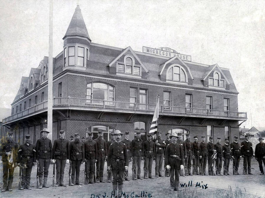 National guard group standing in front. Dr. J.H. McCallie and Will Mix identified. House later became Gritman Hospital