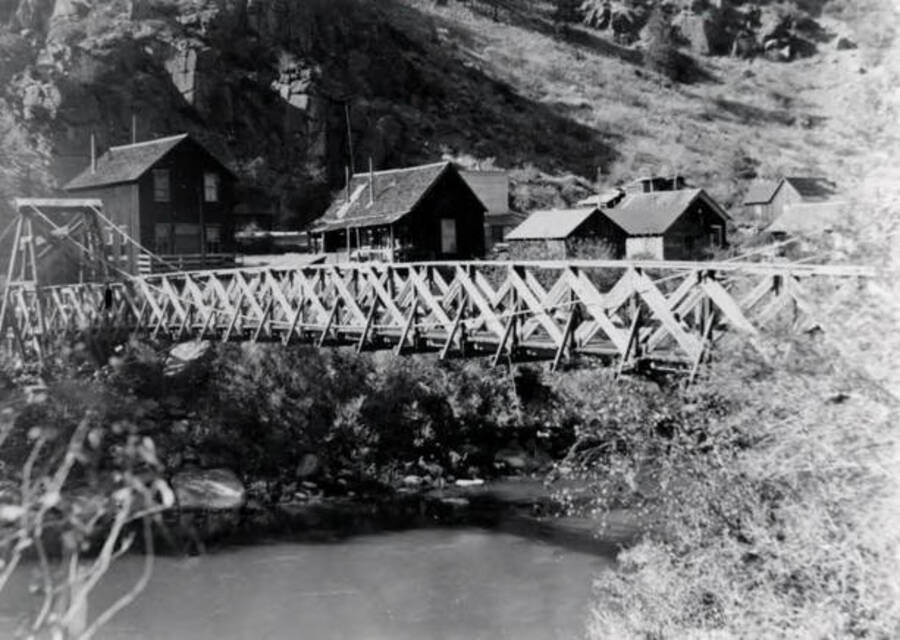 Clayton, Idaho showing bridge across river and homes.