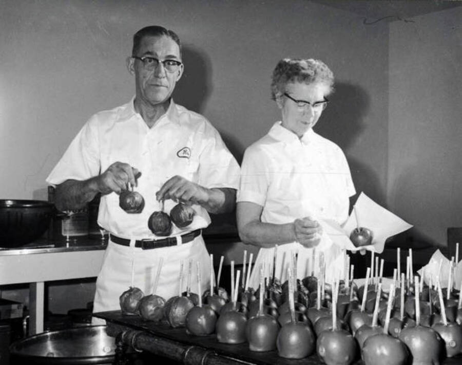 Ray and Anna Hunter showing caramel apples that were shipped around world during WWII