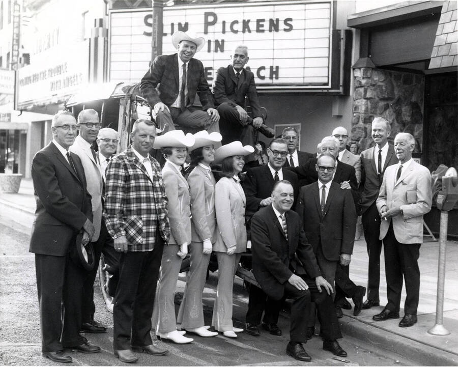 Group posed in the street with Governor Robert Smylie, Slim Pickens and three rodeo royalty