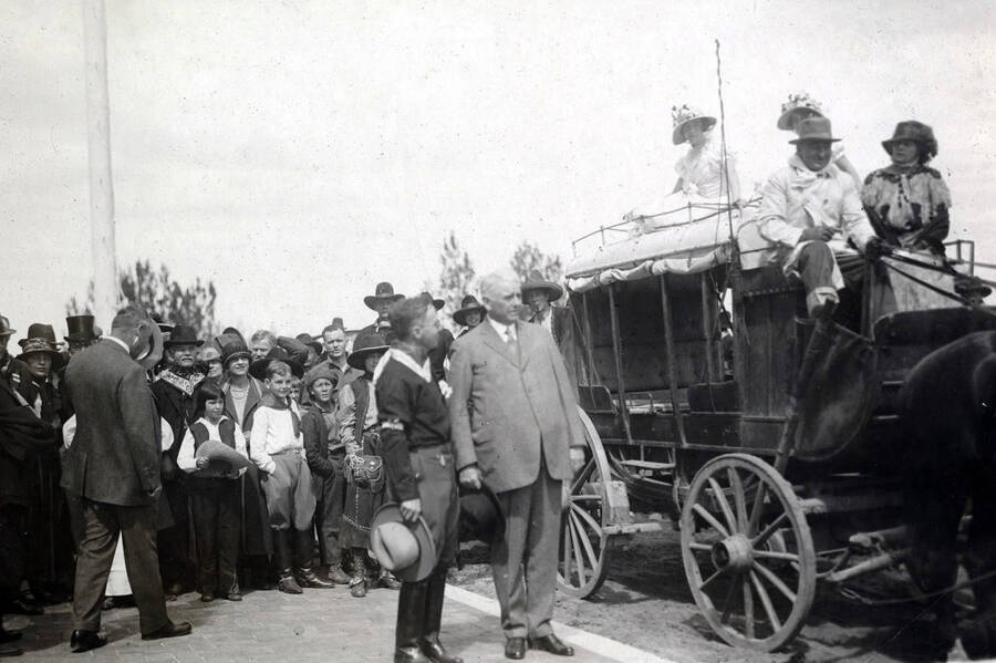 U.P. President Carl R. Gray preparing to ride in old stagecoach. Celebration of coming of Union Pacific main line to Boise. Boise, Idaho.