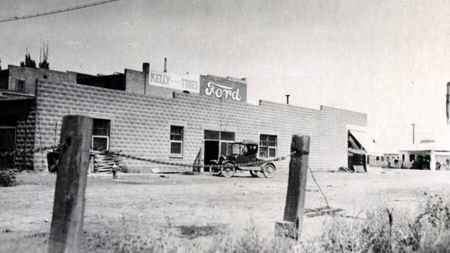 Exterior view of former creamery with Ford sign and Kelly Tires sign. Gooding, Idaho.
