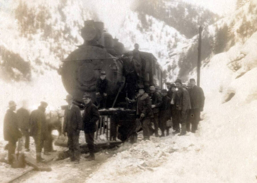 Group in front of train engine after the snowslide. Mace, Idaho.
