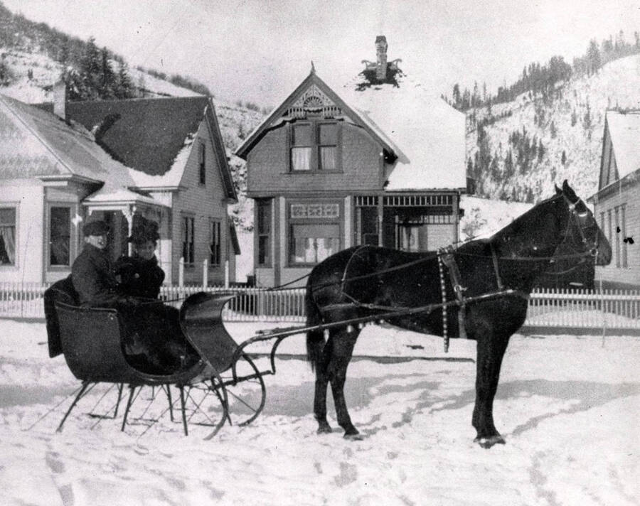 Couple seated on horse-drawn sleigh. Wallace, Idaho?