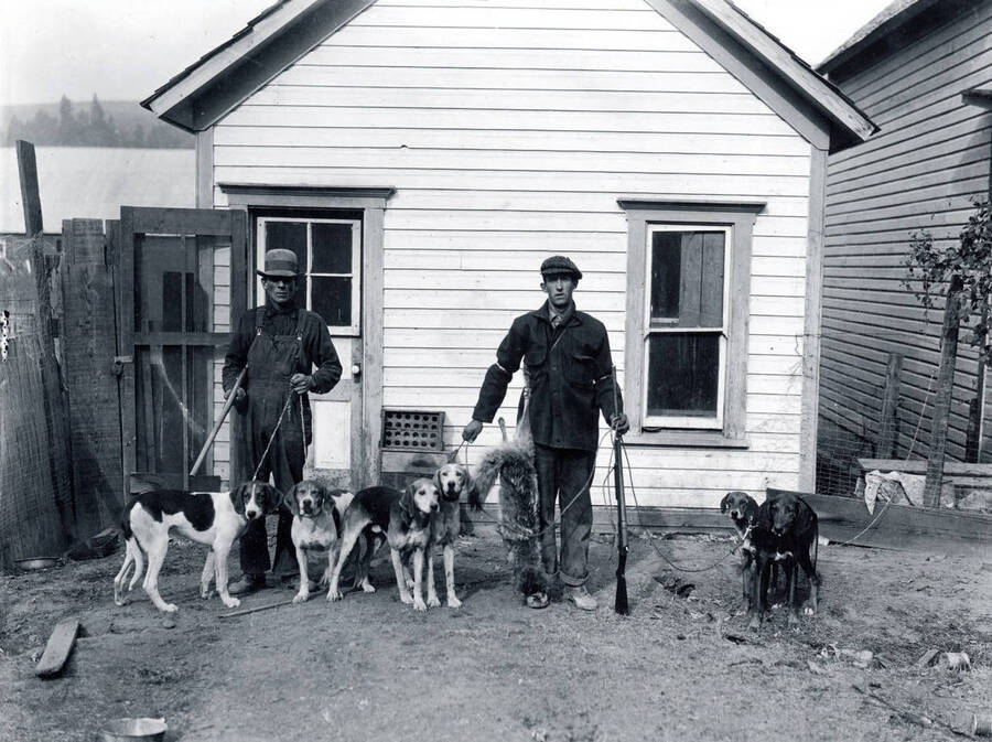 Henry Weeks and Abe Weeks with hunting dogs.